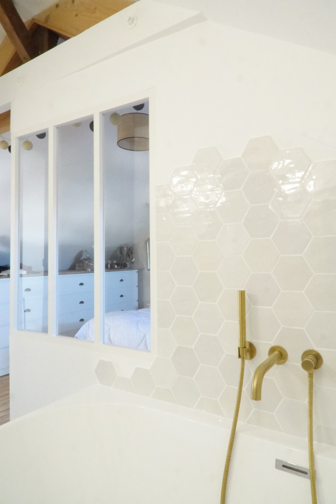 This is an example of a small modern 3/4 bathroom in Other with beaded inset cabinets, light wood cabinets, a drop-in tub, a wall-mount toilet, white tile, porcelain tile, white walls, vinyl floors, a drop-in sink, laminate benchtops, beige floor, white benchtops, a single vanity, a freestanding vanity, exposed beam and wallpaper.