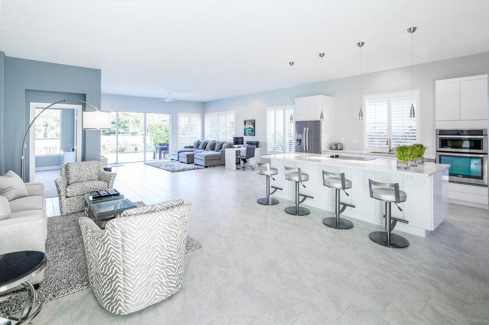 Photo of a contemporary open plan kitchen in Miami with ceramic floors, flat-panel cabinets, white cabinets, stainless steel appliances and with island.