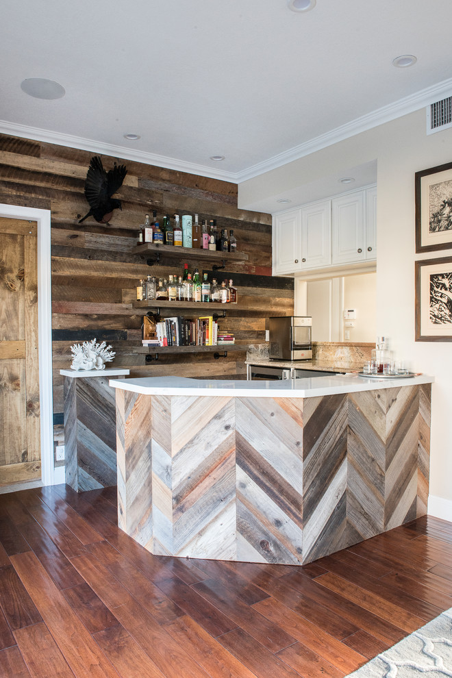 Photo of a mid-sized contemporary single-wall wet bar in Orange County with medium hardwood floors, brown floor and white benchtop.