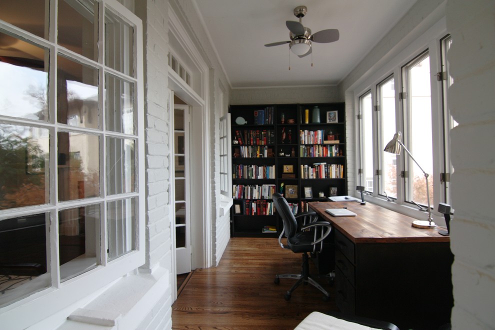 Photo of a mid-sized arts and crafts study room in Atlanta with white walls, medium hardwood floors and a freestanding desk.