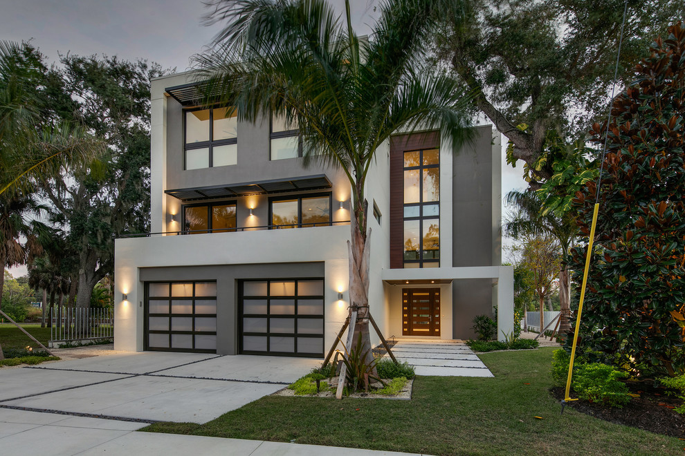 Mid-sized modern three-storey stucco white house exterior in Tampa with a flat roof.