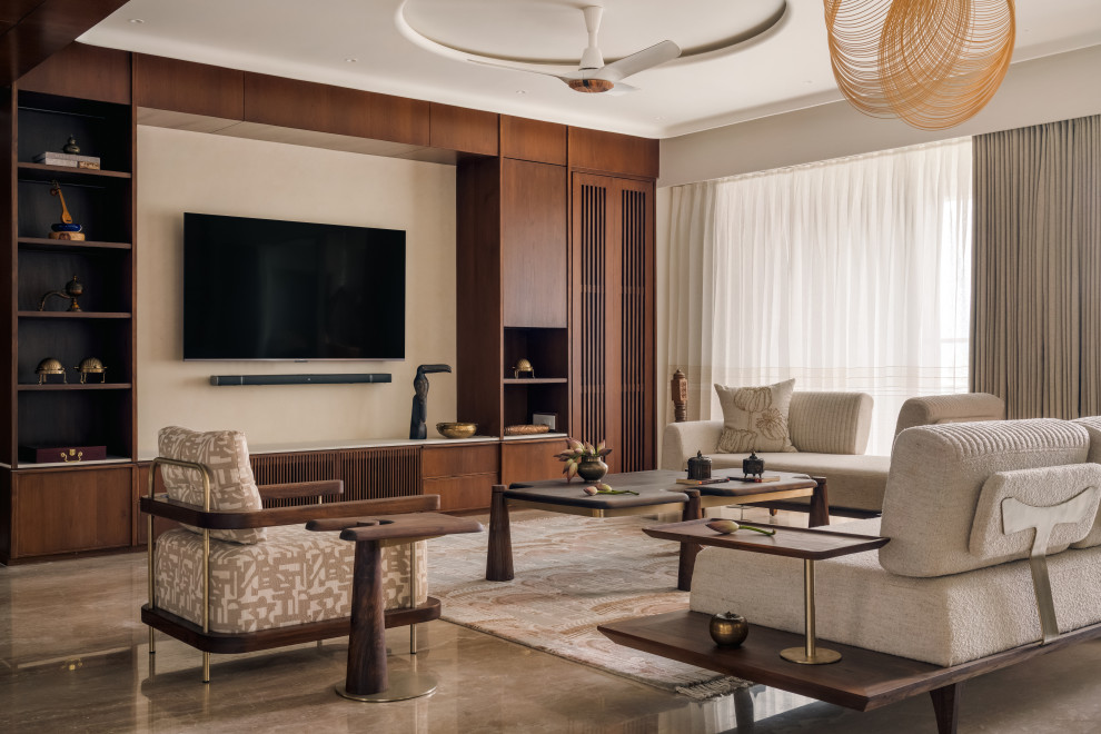 This is an example of a contemporary Open Concept living room in Ahmedabad With Beige Walls, a Wall-mounted TV and Gray.