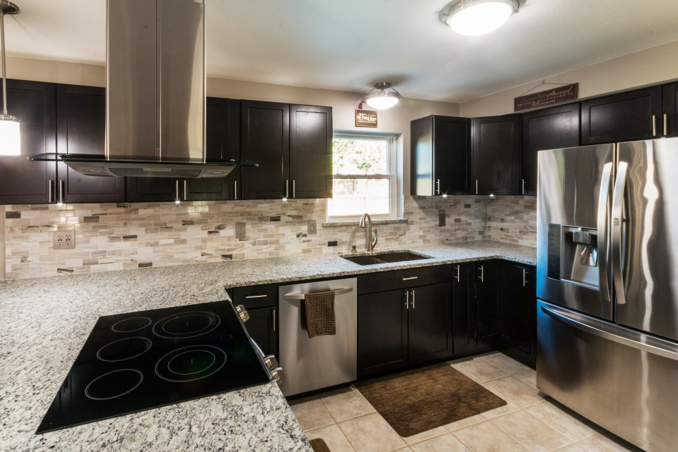 Inspiration for a mid-sized u-shaped ceramic tile and beige floor eat-in kitchen remodel with an undermount sink, shaker cabinets, black cabinets, granite countertops, glass tile backsplash, stainless steel appliances, an island and white countertops
