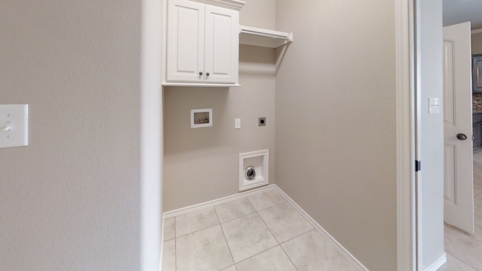 Inspiration for a mid-sized traditional dedicated laundry room in Other with raised-panel cabinets, white cabinets, concrete benchtops, beige walls, ceramic floors, a side-by-side washer and dryer and beige floor.