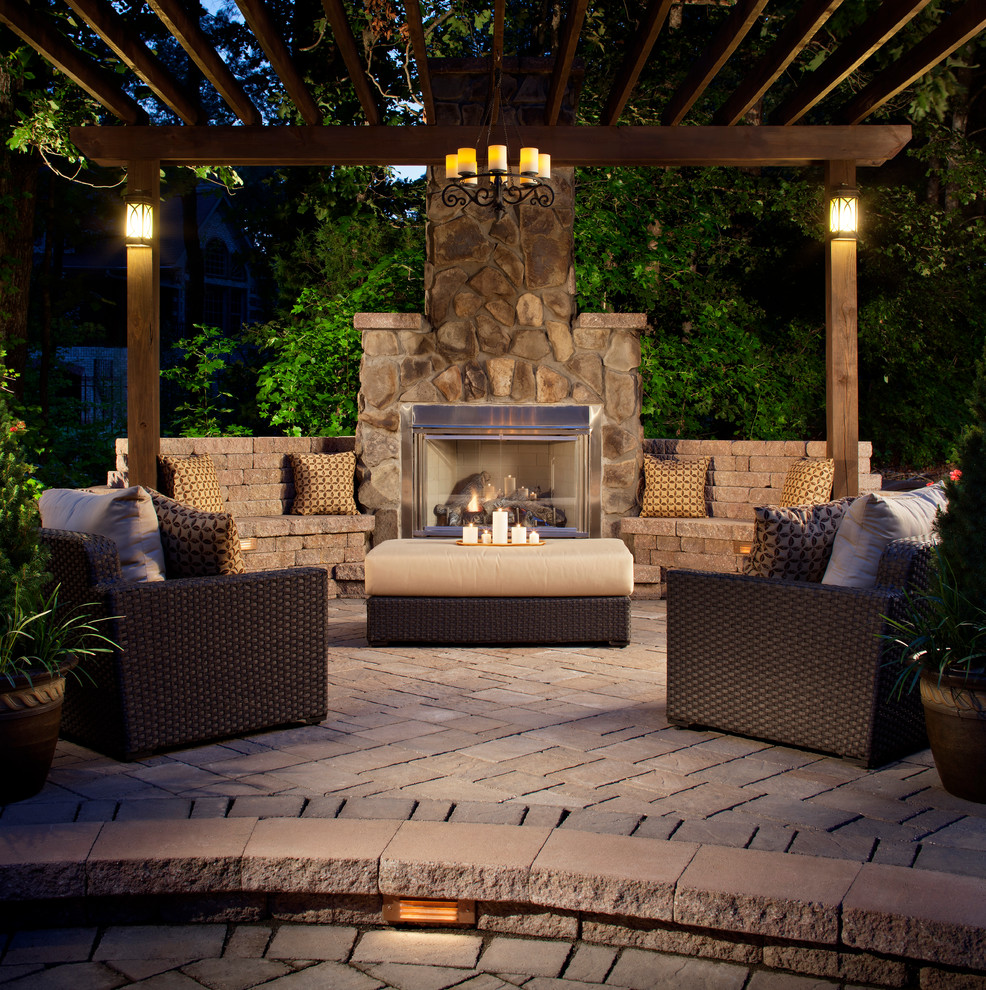 Inspiration for a large arts and crafts backyard patio in Denver with a fire feature, brick pavers and a pergola.