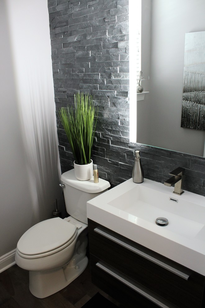 Inspiration for a mid-sized modern powder room in Philadelphia with flat-panel cabinets, medium wood cabinets, a one-piece toilet, gray tile, grey walls, medium hardwood floors, a wall-mount sink and slate.