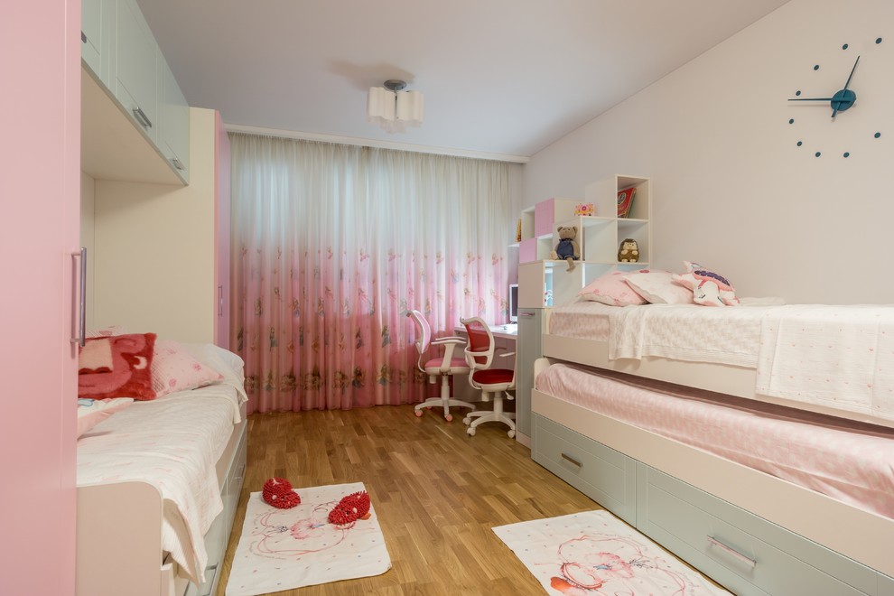 Photo of a mid-sized contemporary kids' study room for kids 4-10 years old and girls in Moscow with white walls, medium hardwood floors and beige floor.