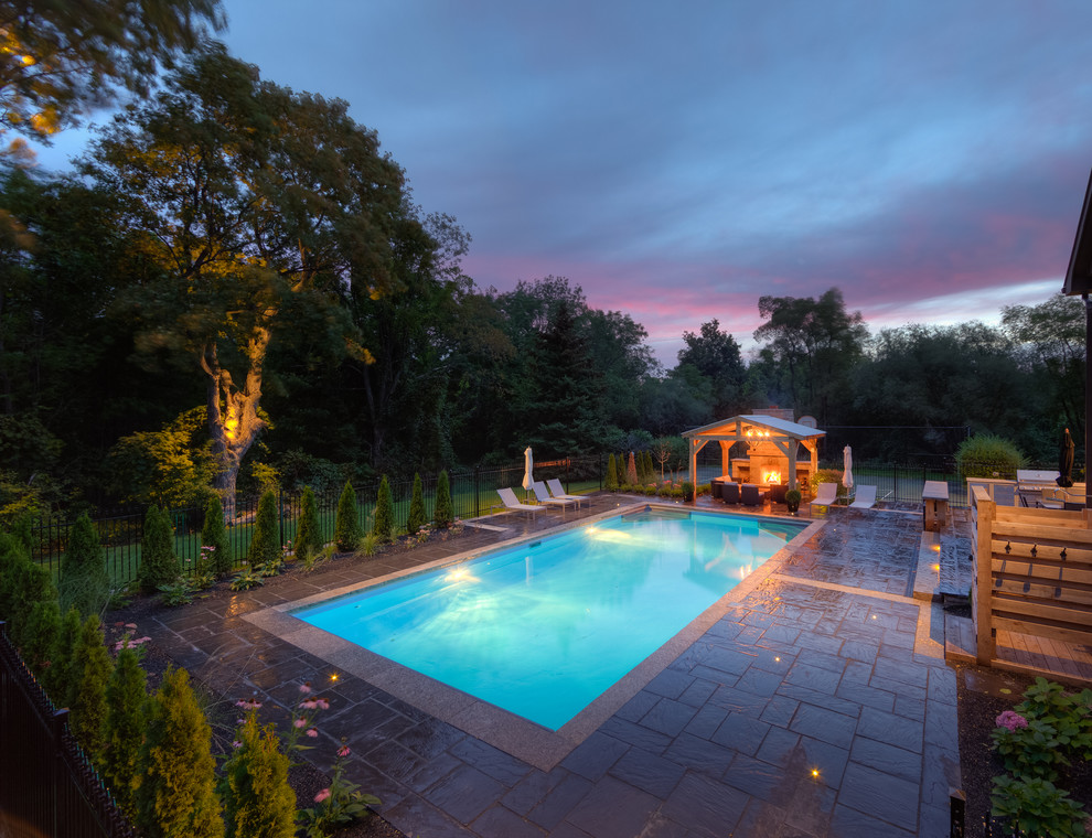 This is an example of an eclectic backyard pool in Toronto.