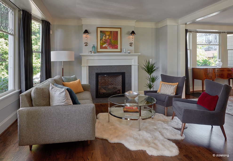 This is an example of a mid-sized arts and crafts formal open concept living room in Seattle with dark hardwood floors, a standard fireplace, grey walls, a tile fireplace surround and no tv.
