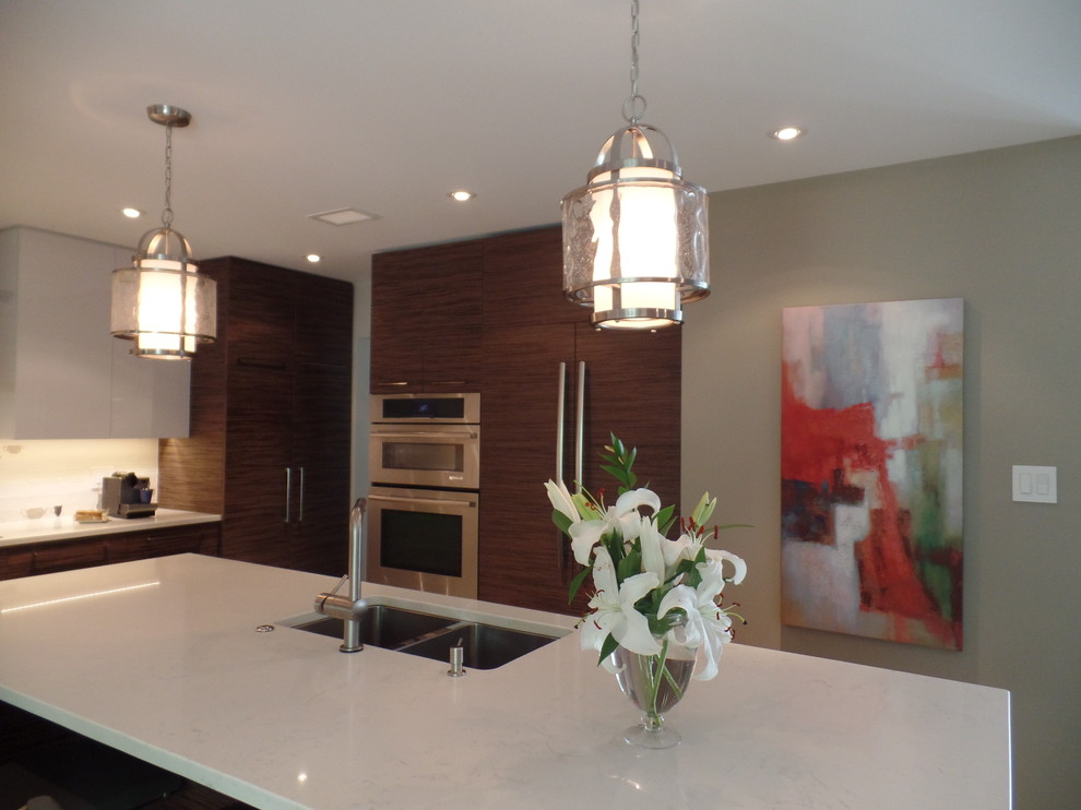Inspiration for a mid-sized transitional l-shaped porcelain tile and beige floor enclosed kitchen remodel with an undermount sink, flat-panel cabinets, medium tone wood cabinets, quartz countertops, white backsplash, subway tile backsplash, paneled appliances and an island
