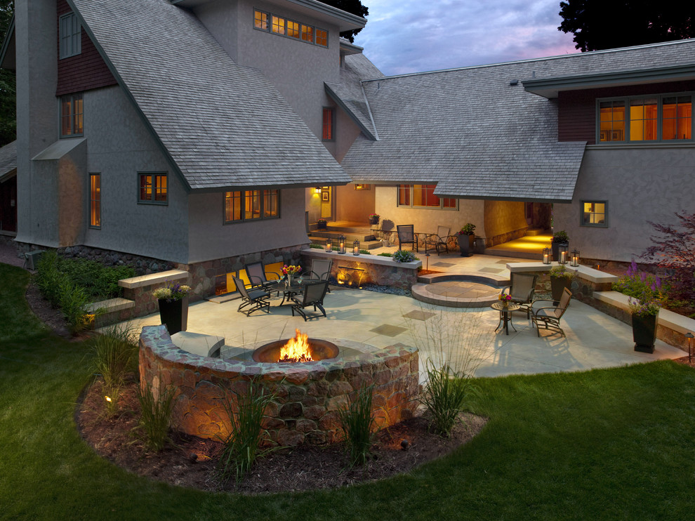 Inspiration for a large arts and crafts backyard patio in Milwaukee with a fire feature and concrete slab.