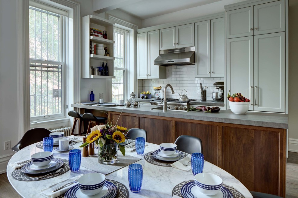 Eat-in kitchen - large transitional galley eat-in kitchen idea in New York with a single-bowl sink, white backsplash and colored appliances