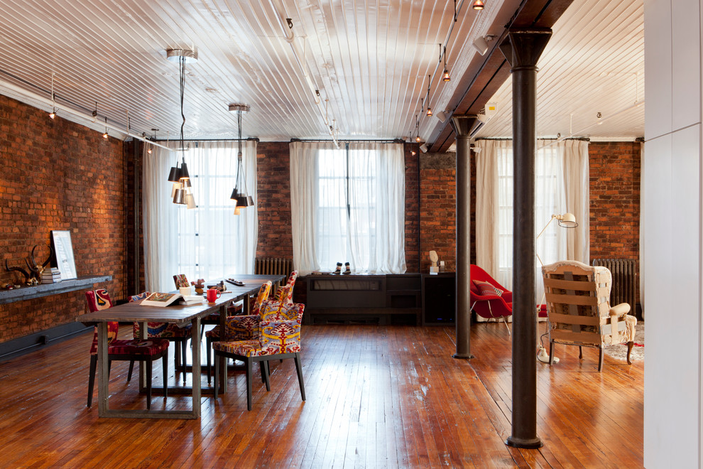 Design ideas for a large industrial open plan dining in New York with medium hardwood floors, no fireplace and red walls.