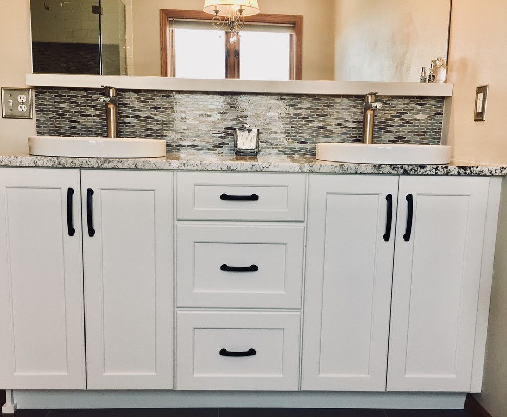 Freestanding bathtub - transitional master multicolored tile and mosaic tile porcelain tile and brown floor freestanding bathtub idea with shaker cabinets, white cabinets, a vessel sink, quartz countertops, a hinged shower door and multicolored countertops