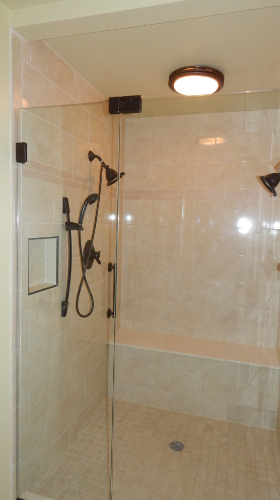 Mid-sized transitional master bathroom in New York with a double shower, beige tile, ceramic tile, porcelain floors, beige floor and a hinged shower door.