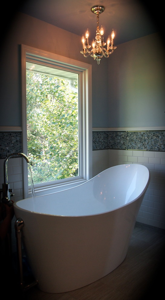 Inspiration for a large master porcelain tile freestanding bathtub remodel with a vessel sink, a one-piece toilet and blue walls