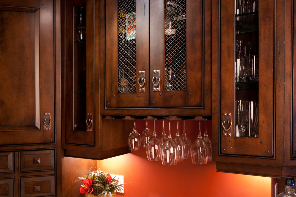 Example of a mid-sized mountain style u-shaped medium tone wood floor home design design in Toronto with raised-panel cabinets, distressed cabinets, granite countertops, paneled appliances and an island