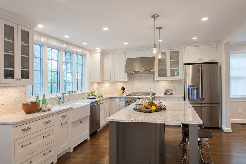 Design ideas for a large traditional l-shaped eat-in kitchen in DC Metro with shaker cabinets, granite benchtops, white splashback, mosaic tile splashback, stainless steel appliances, with island, a farmhouse sink, white cabinets, dark hardwood floors and brown floor.