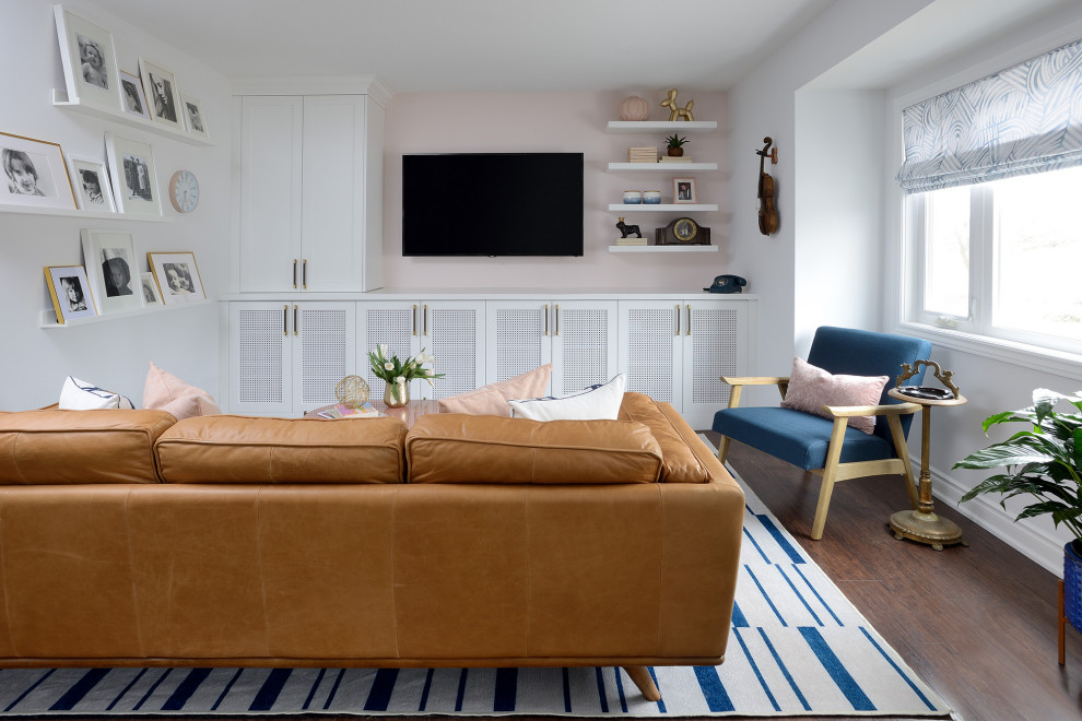 Large transitional open concept medium tone wood floor and brown floor living room photo in Toronto with white walls and a media wall