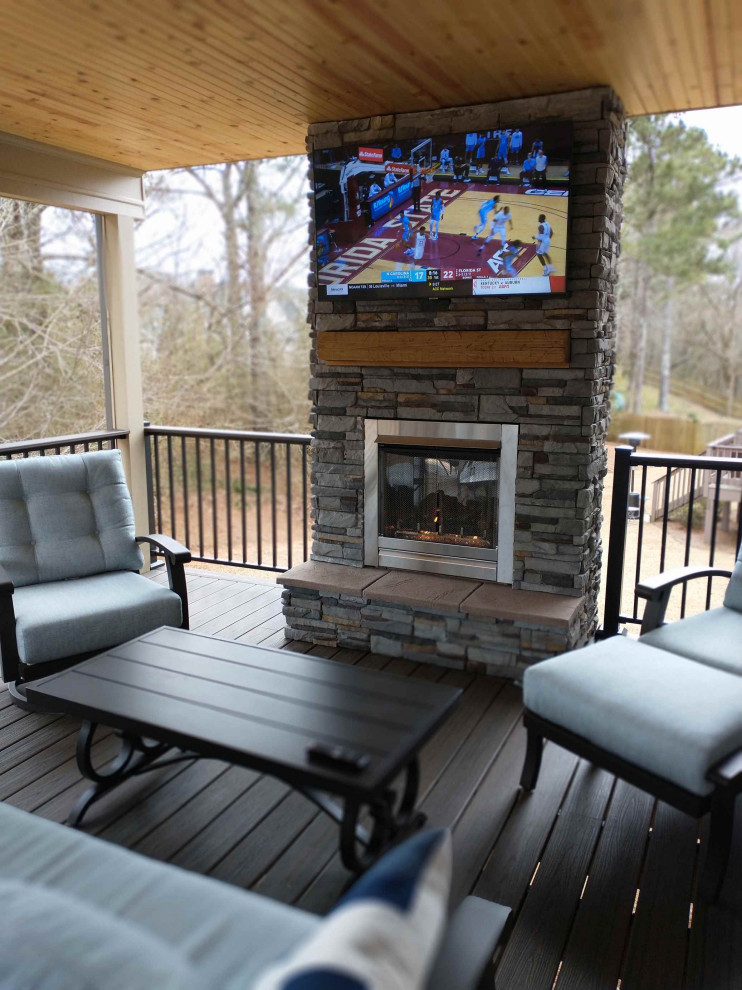 Deck - mid-sized traditional backyard metal railing deck idea in Atlanta with a fireplace and a roof extension