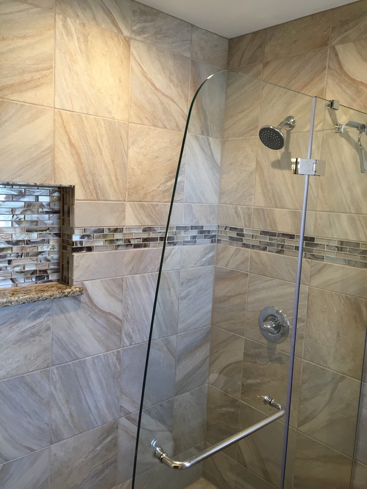 Corner shower - transitional gray tile and porcelain tile beige floor corner shower idea with a hinged shower door