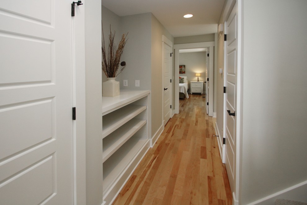 Arts and crafts hallway in Indianapolis with grey walls and light hardwood floors.