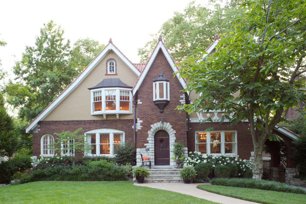 Photo of a large traditional three-storey brick multi-coloured exterior in St Louis with a gable roof.