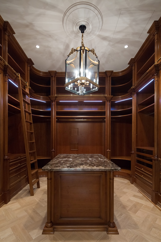 Photo of an expansive traditional walk-in wardrobe in Moscow with open cabinets, dark wood cabinets, medium hardwood floors and beige floor.