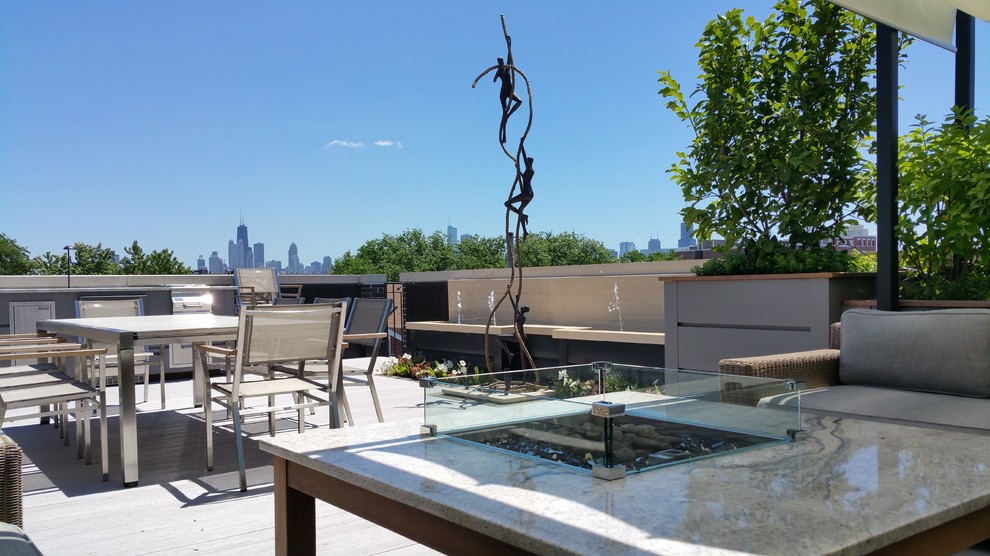 Inspiration for a large traditional rooftop deck in Chicago with a fire feature and a pergola.