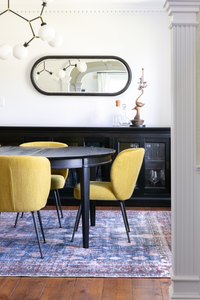 Enclosed dining room - transitional dark wood floor and brown floor enclosed dining room idea in New York with white walls