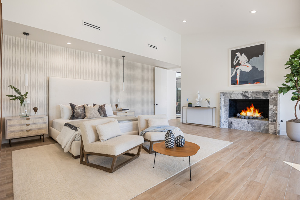 Bedroom - large transitional master porcelain tile, beige floor, vaulted ceiling and wallpaper bedroom idea with white walls, a standard fireplace and a stone fireplace