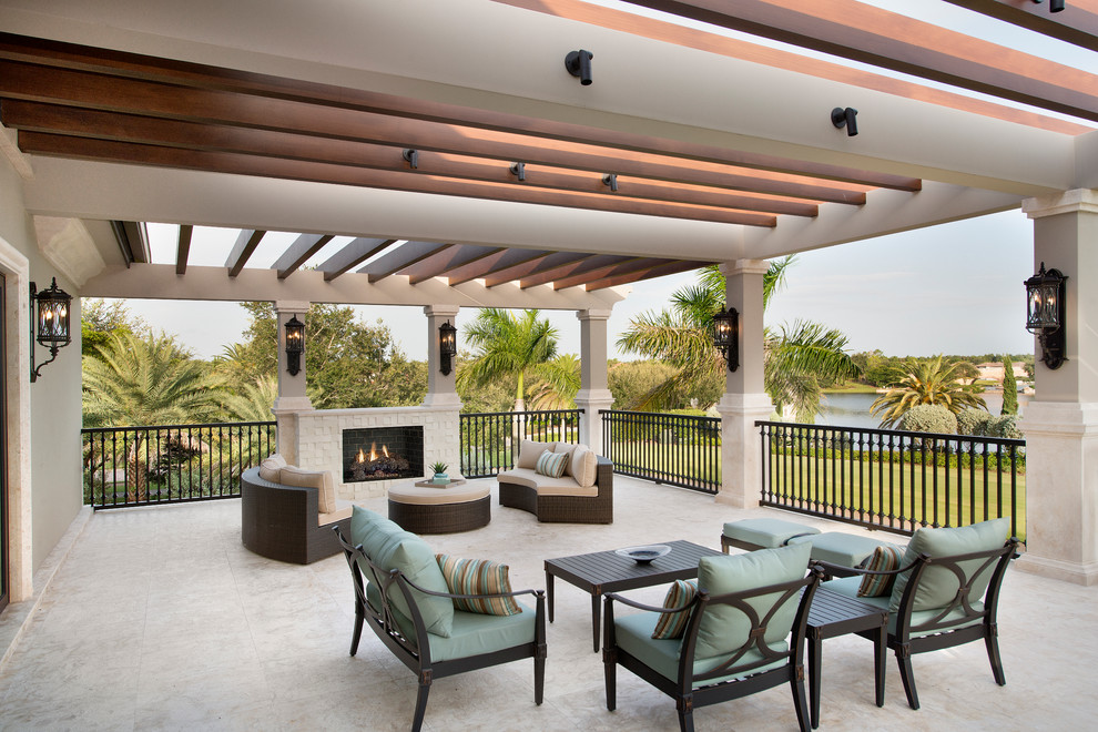 Inspiration for a large transitional backyard patio in Miami with a fire feature and a pergola.