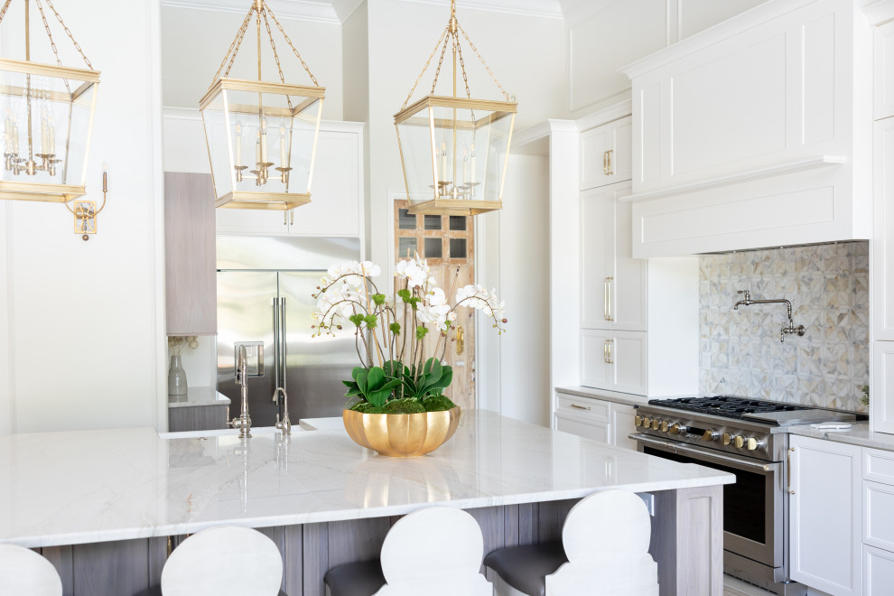 Kitchen - large transitional porcelain tile and beige floor kitchen idea in Orlando with a farmhouse sink, recessed-panel cabinets, white cabinets, quartzite countertops, multicolored backsplash, marble backsplash, stainless steel appliances, an island and beige countertops