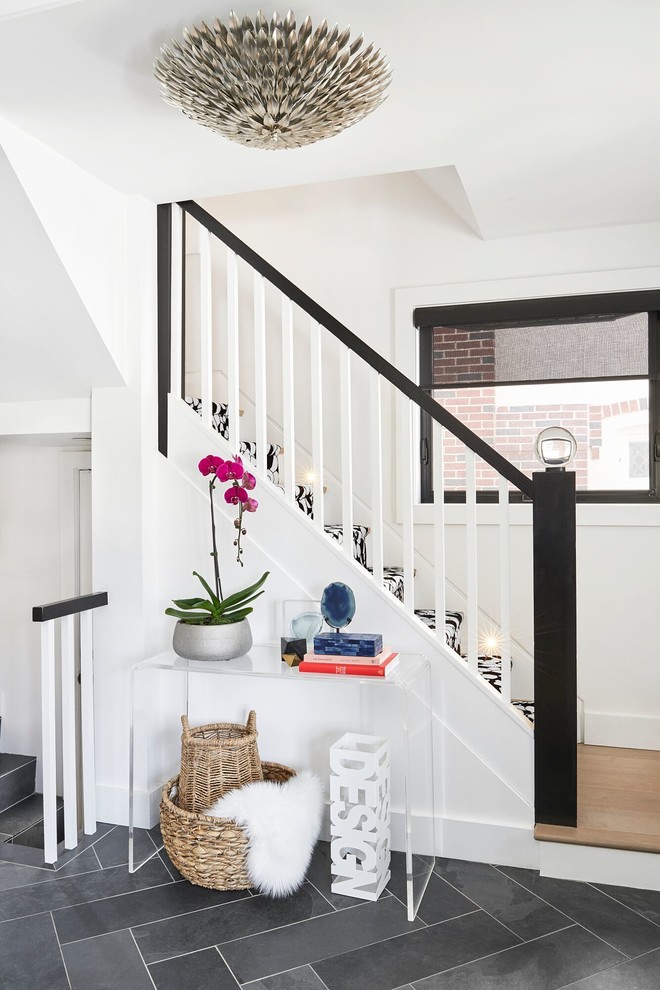 Mid-sized transitional slate floor home design photo in Toronto with white walls and a medium wood front door