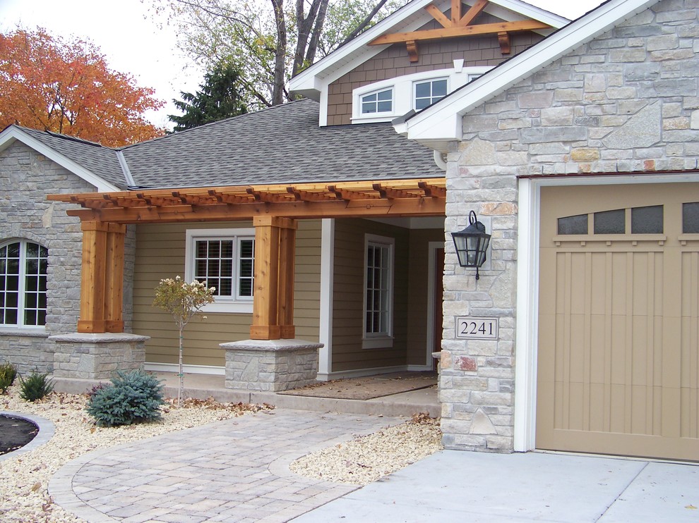 This is an example of an expansive arts and crafts front door in Minneapolis with brown walls, concrete floors, a single front door and a medium wood front door.