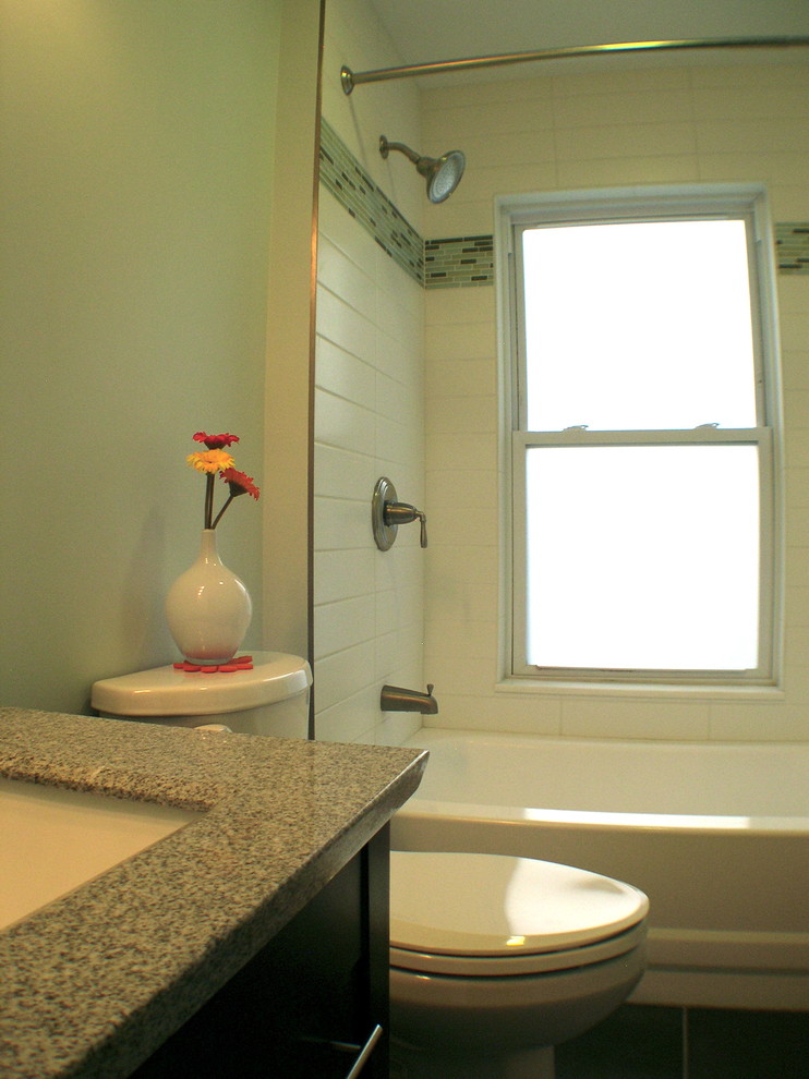 Photo of a small modern bathroom in Philadelphia with an undermount sink, shaker cabinets, dark wood cabinets, granite benchtops, an alcove tub, a shower/bathtub combo, gray tile, ceramic tile, green walls and ceramic floors.