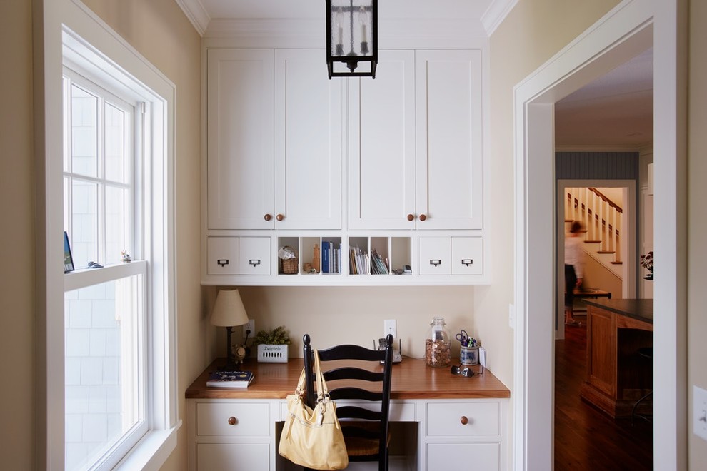 Small country hallway in Minneapolis with beige walls, dark hardwood floors and brown floor.