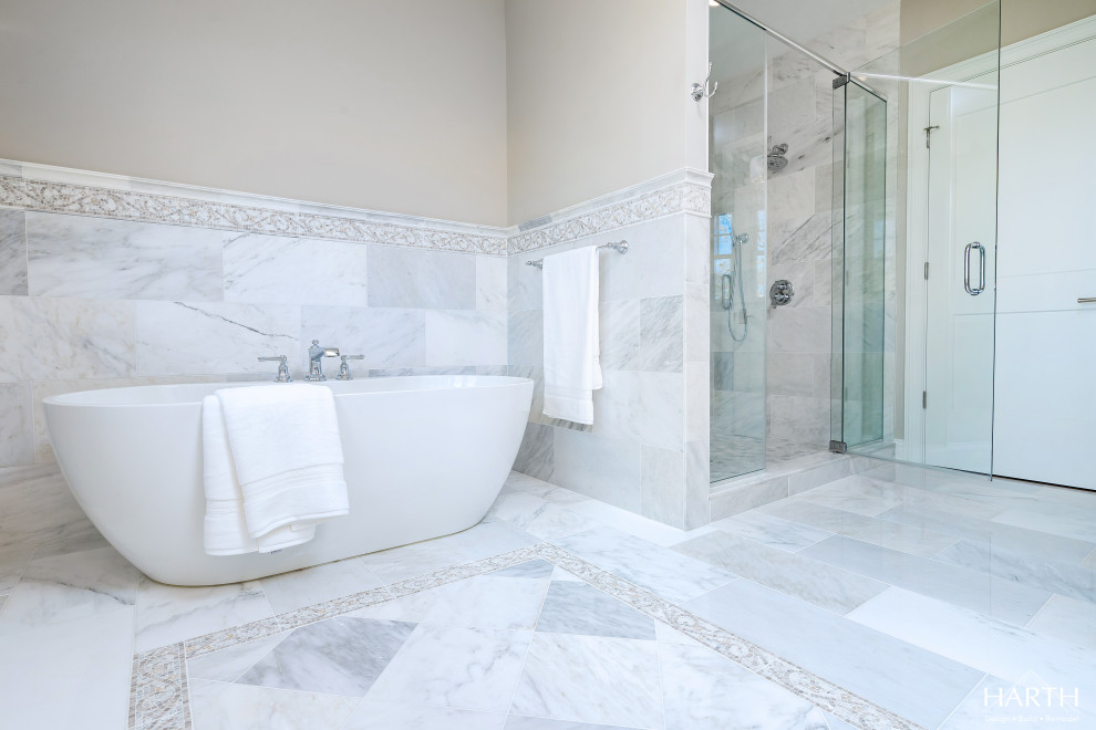 Design ideas for a mid-sized transitional master bathroom in Philadelphia with raised-panel cabinets, beige cabinets, a freestanding tub, an alcove shower, a one-piece toilet, gray tile, marble, beige walls, marble floors, an undermount sink, engineered quartz benchtops, grey floor, a hinged shower door, white benchtops, a niche, a double vanity and a built-in vanity.
