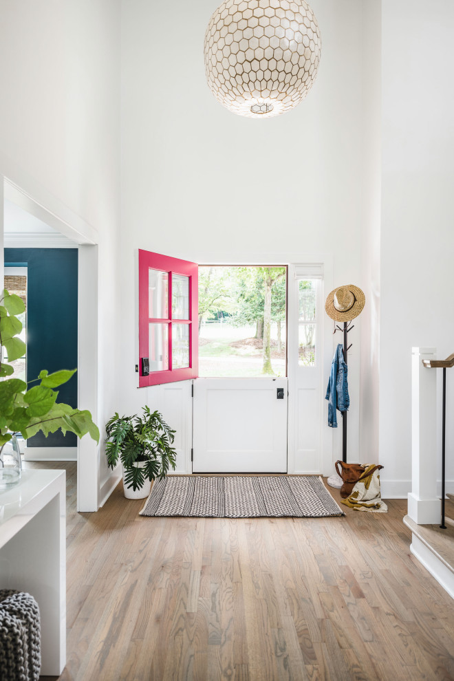 Mid-sized beach style light wood floor and multicolored floor entryway photo in Charlotte with white walls and a red front door