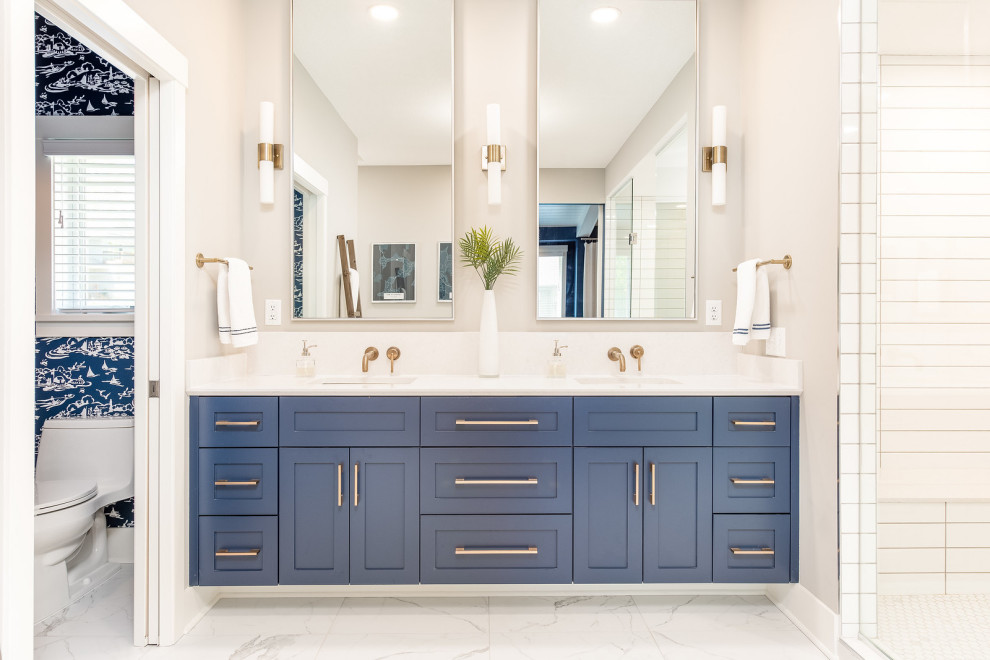 Photo of a beach style master bathroom in Minneapolis with shaker cabinets, black cabinets, a freestanding tub, a shower/bathtub combo, a two-piece toilet, white tile, subway tile, grey walls, porcelain floors, a drop-in sink, engineered quartz benchtops, white floor, grey benchtops, a shower seat, a double vanity, a built-in vanity and wallpaper.