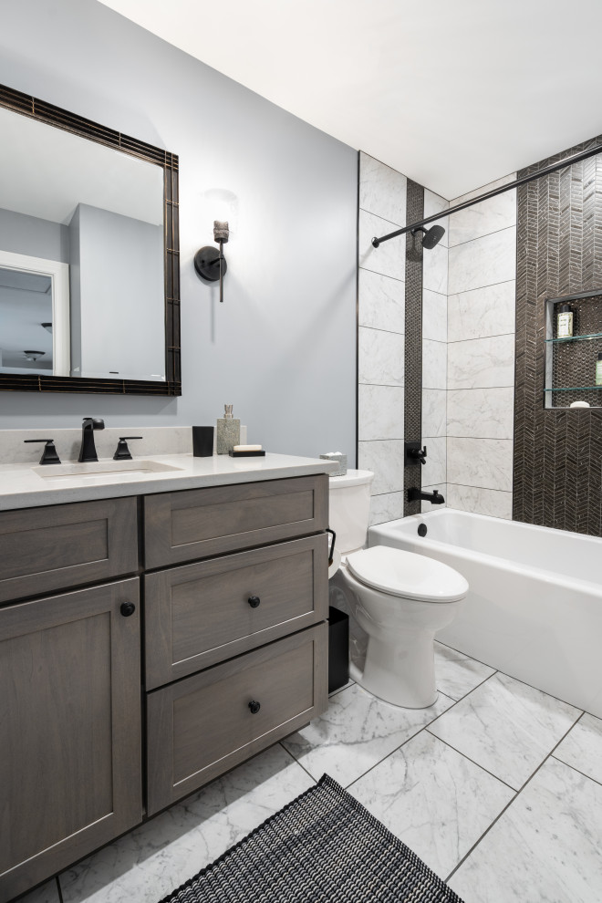 Inspiration for a mid-sized contemporary 3/4 bathroom in St Louis with flat-panel cabinets, medium wood cabinets, an alcove tub, an alcove shower, a two-piece toilet, black and white tile, ceramic tile, grey walls, porcelain floors, an undermount sink, engineered quartz benchtops, white floor, a shower curtain, white benchtops, a niche, a single vanity and a built-in vanity.