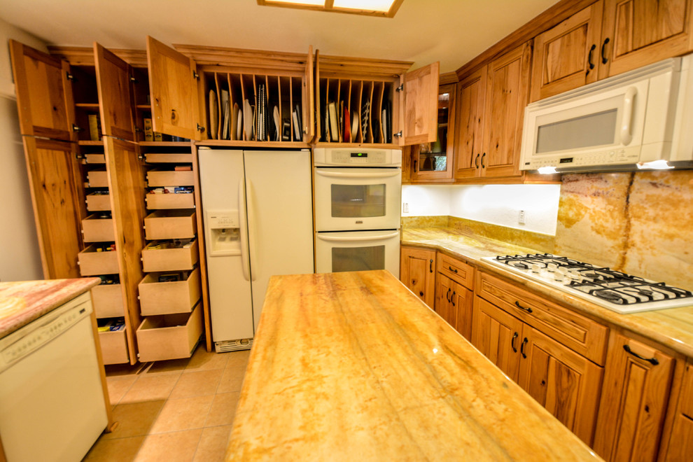 This is an example of a mid-sized country kitchen pantry in San Diego with raised-panel cabinets, light wood cabinets, granite benchtops and with island.