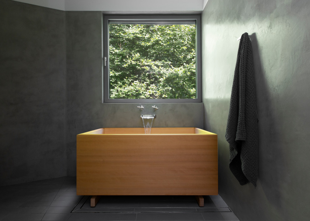 Photo of a mid-sized midcentury master bathroom in Seattle with a floating vanity, flat-panel cabinets, light wood cabinets, a japanese tub, a shower/bathtub combo, gray tile, grey walls, an undermount sink, solid surface benchtops, grey floor, an open shower, white benchtops and a double vanity.