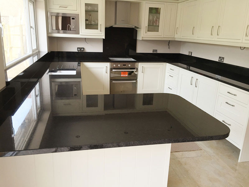 This is an example of a country kitchen in London with granite benchtops and black benchtop.