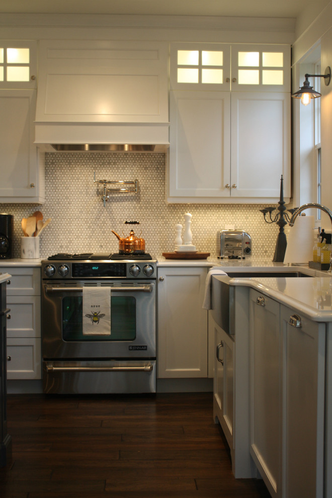 Inspiration for a mid-sized transitional l-shaped kitchen remodel with shaker cabinets, white cabinets, white backsplash, stainless steel appliances, an island, a double-bowl sink and mosaic tile backsplash
