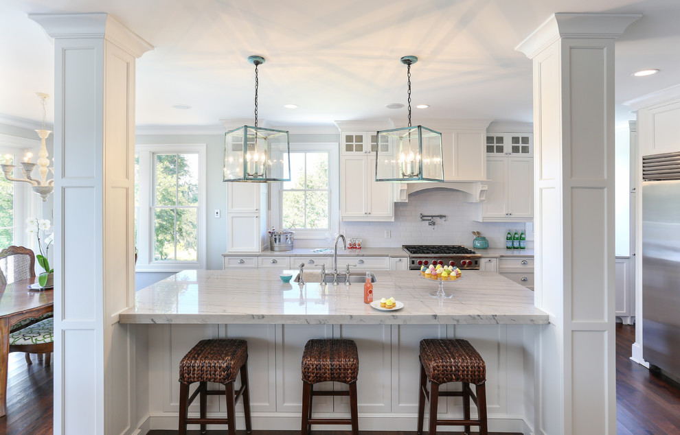 This is an example of a traditional eat-in kitchen in San Francisco with recessed-panel cabinets, quartzite benchtops, white cabinets, white splashback, subway tile splashback and stainless steel appliances.