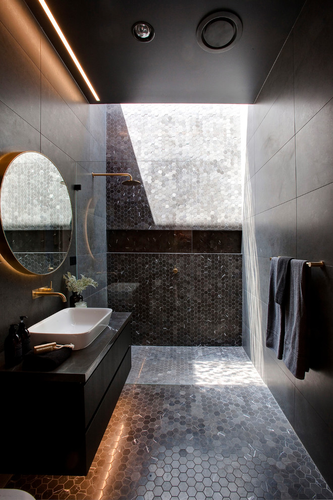 Inspiration for a contemporary 3/4 bathroom in Sydney with flat-panel cabinets, black cabinets, an alcove shower, black tile, gray tile, black walls, mosaic tile floors, a vessel sink, black floor and an open shower.