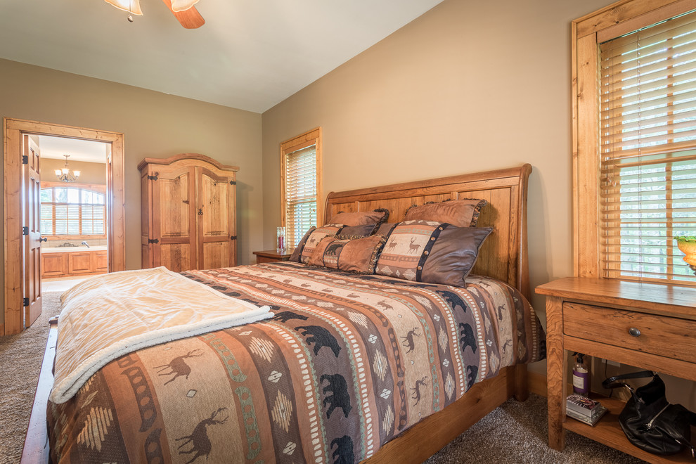 This is an example of a mid-sized country master bedroom in Charlotte with beige walls, carpet and no fireplace.