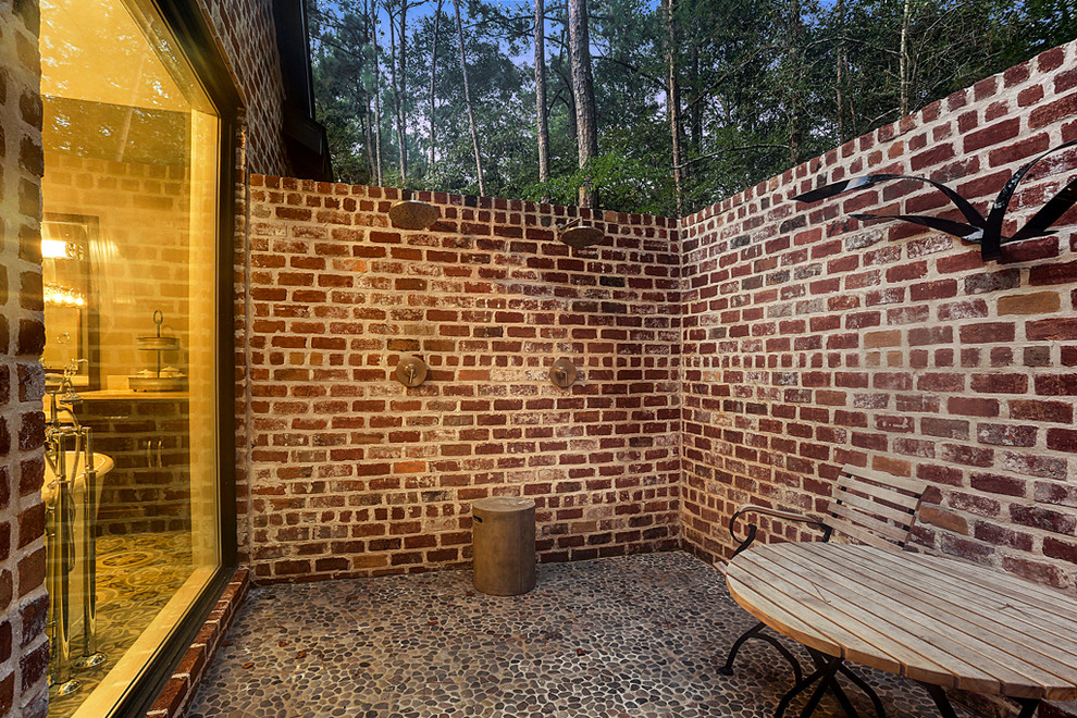 Inspiration for a large country side yard patio in Houston with an outdoor shower, natural stone pavers and no cover.