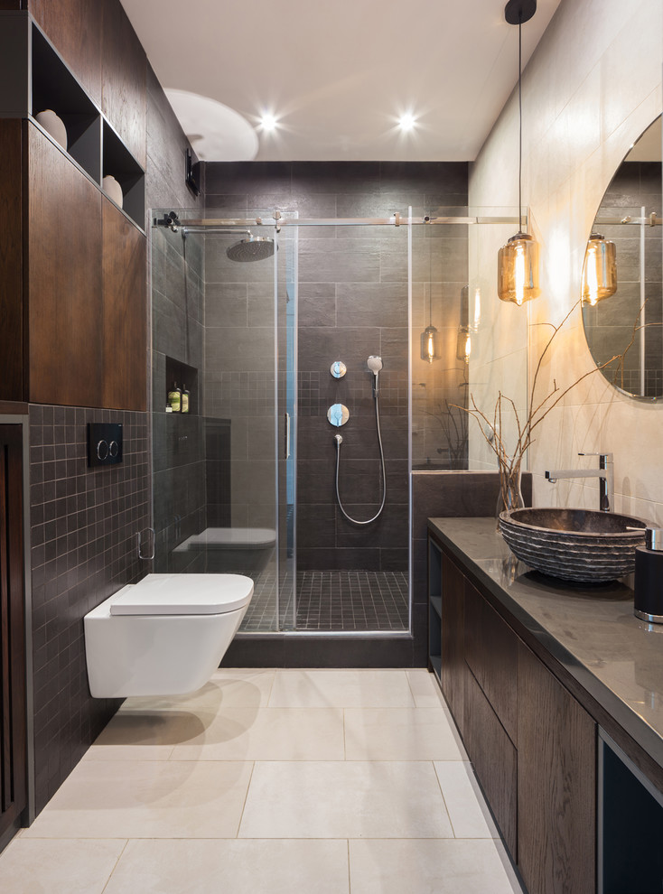 Small contemporary 3/4 bathroom in Moscow with flat-panel cabinets, dark wood cabinets, black tile, porcelain tile, beige walls, ceramic floors, a vessel sink, solid surface benchtops, beige floor, a sliding shower screen, an alcove shower, grey benchtops and a wall-mount toilet.